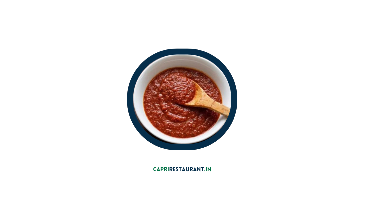 Aurelio's Pizza Sauce in a bowl with fresh tomatoes and basil